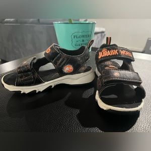 Jurassic World to your little one's feet with these toddler dinosaur sandals!